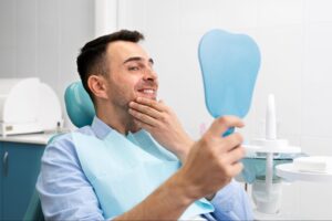 patient smiling at results sitting in chair