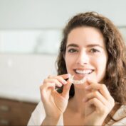 woman holding aligners